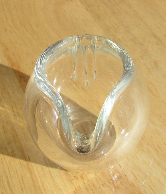 Handmade strainer pot thaws and rinses frozen food in the same